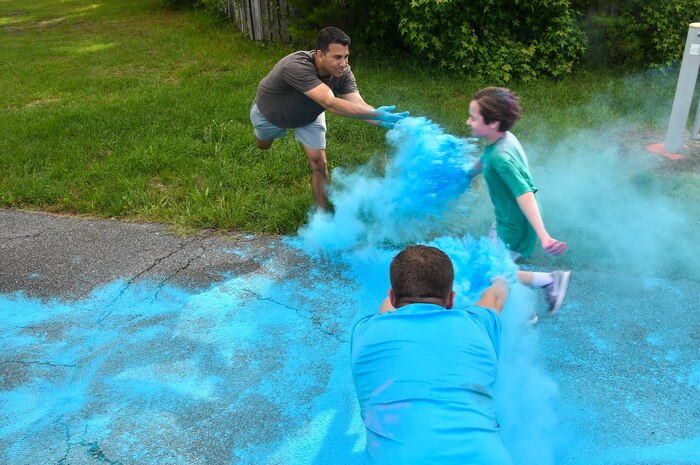A child from the Joint Base Charleston Youth Center runs through colored chalk during a color run May 18, 2018, at JB Charleston, S.C.