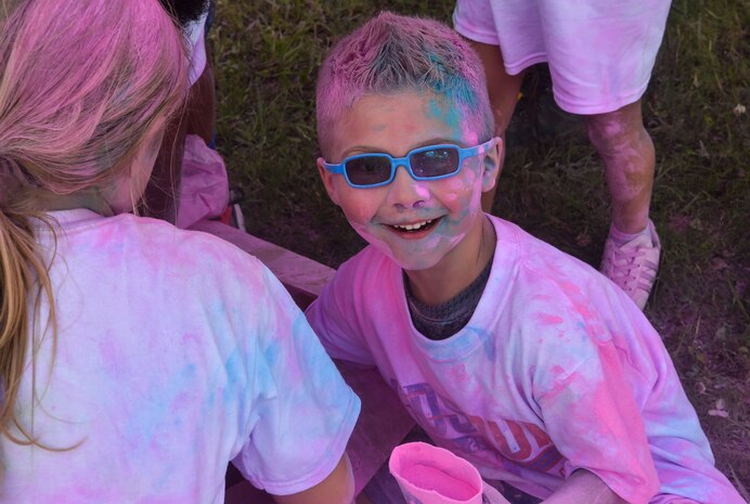 A child from the Joint Base Charleston Youth Center plays with leftover chalk at the Annual Armed Forces Kids Color Run, May 18, 2018, at Joint Base Charleston.