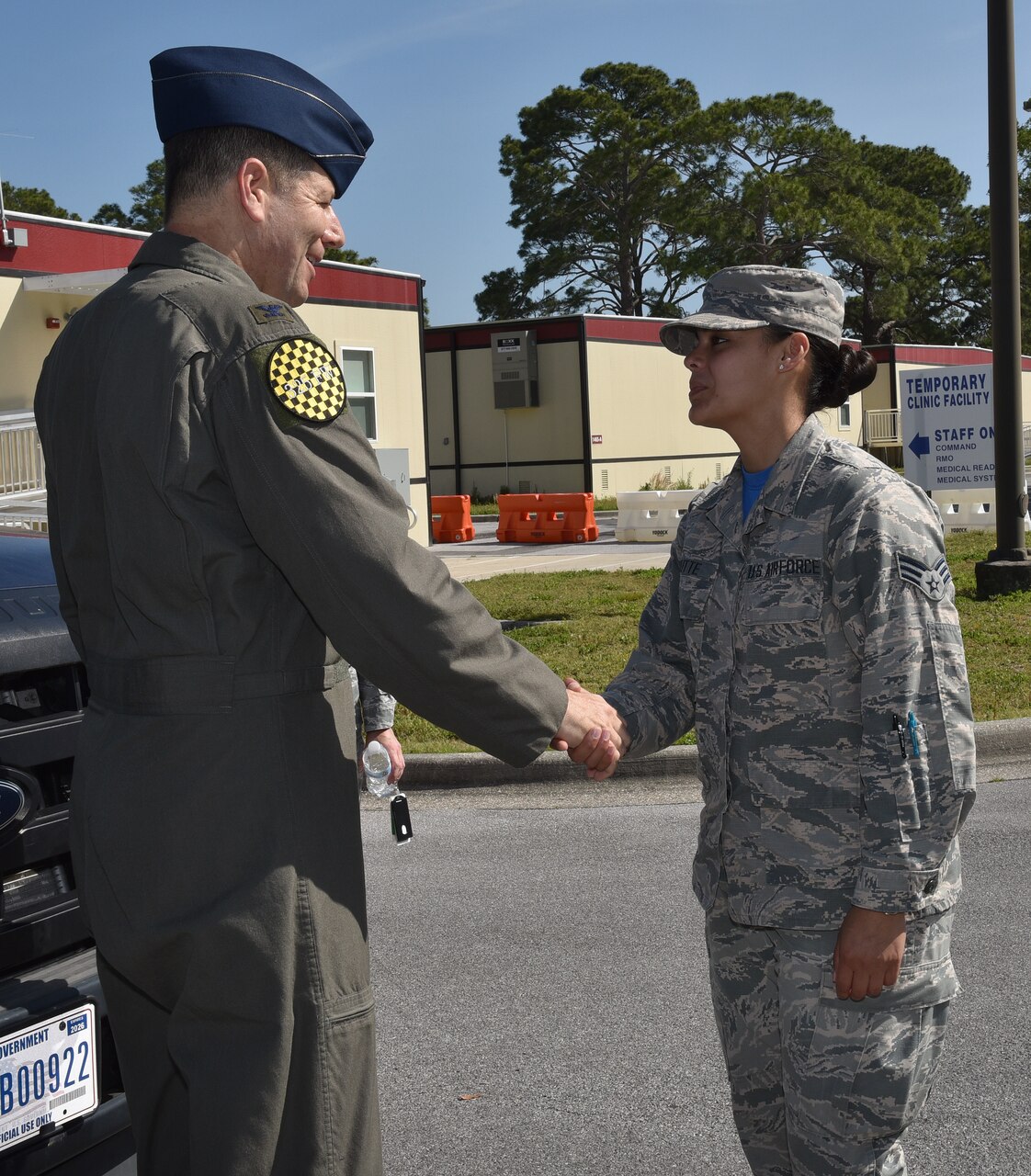 U.S. Air Force Col. Michael Hernandez, 325th Fighter Wing commander, coins Senior Airman Dannyel Butt.