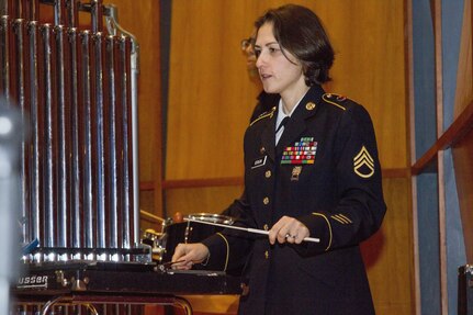 U.S. Army Staff Sgt. Yulia Benson, bandsman, 40th Army Band, Vermont Army National Guard plays during a concert.