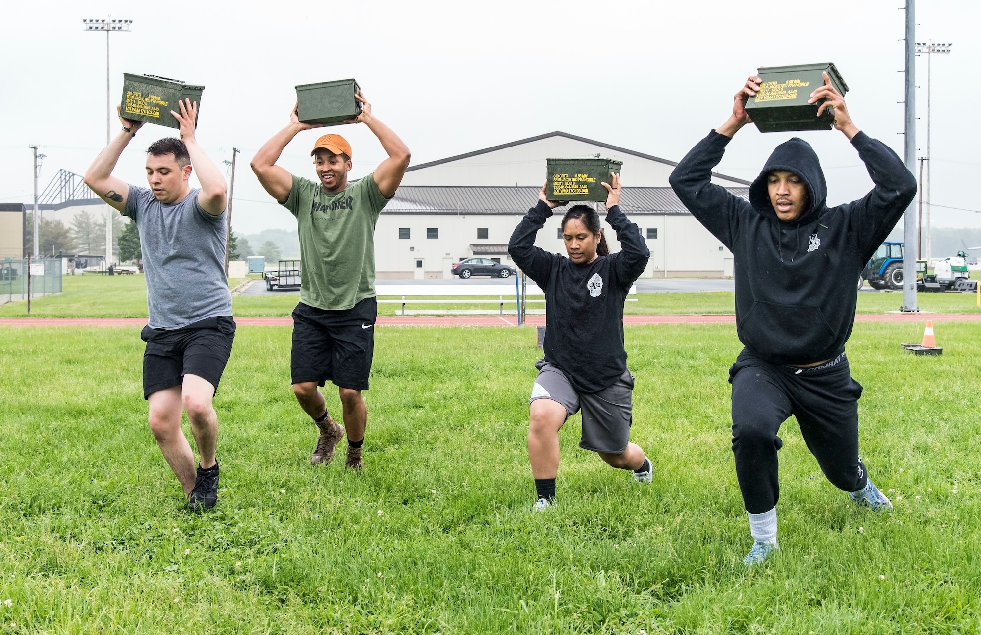 From left, Staff Sgt. Kevin Garcia, Senior Airman Norman Mosby-Hauer, Staff Sgt. Charnelle Albino and Airman 1st Class Daniel Evans, all from the 436th Security Forces Squadron, perform ammo can lunges during the Police Week Combat Fitness Challenge May 17, 2018, at Dover Air Force Base, Del. Upon completing all nine challenges, the team finished in second place posting a time of 6 minutes. (U.S. Air Force photo by Roland Balik)