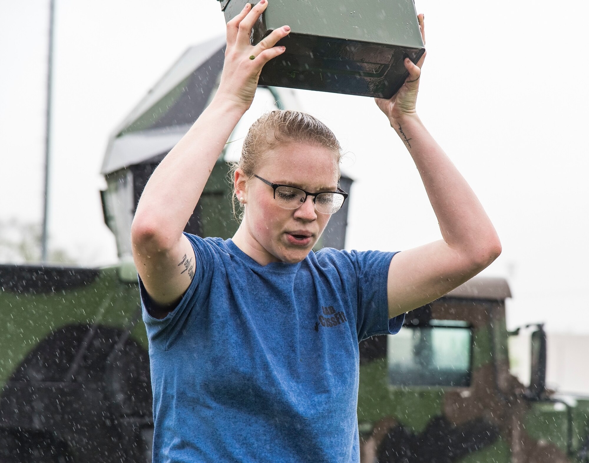 Airman 1st Class Lakyn Wedlock, 436th Security Forces Squadron, performs ammo can lunges in the rain during the Police Week Combat Fitness Challenge May 17, 2018, at Dover Air Force Base, Del. Wedlock and her three teammates completed eight other challenges consisting of a Rescue Randy Pull, fireman’s carry, high crawl, tire flip, 100-meter sprint, buddy drag, 50 ruck squats and 50 ruck presses. (U.S. Air Force photo by Roland Balik)