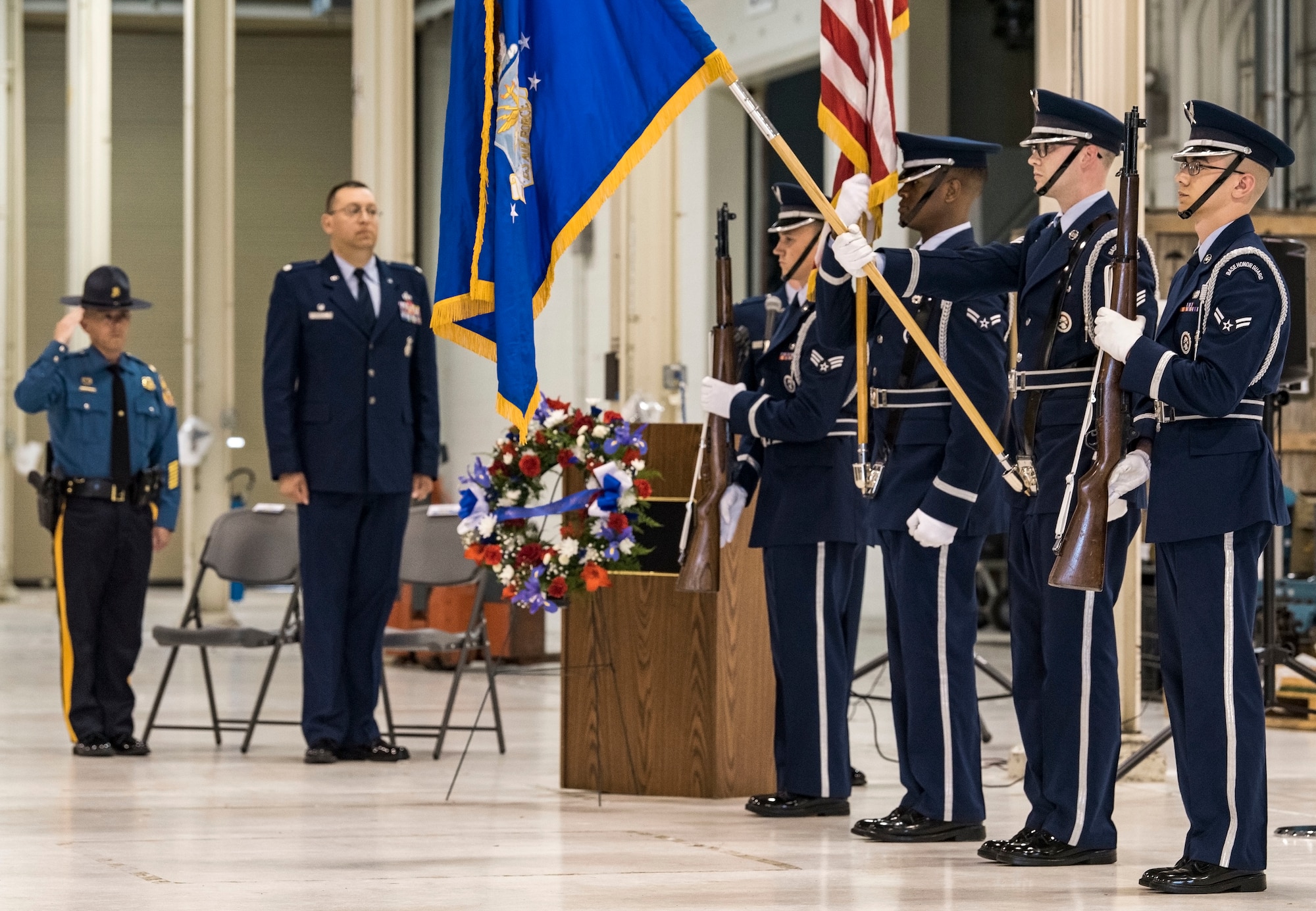 A 436th Airlift Wing Base Honor Guard detail posts the colors at the start of the National Police Week Remembrance Ceremony May 18, 2018, at Dover Air Force Base, Del. Maj. Sean Moriarty (left), Delaware State Police operations officer for Kent and Sussex Counties in Delaware, was the guest speaker for the ceremony. Lt. Col. Michael Morales (center left), 436th Security Forces Squadron commander, hosted the event honoring 14 fallen Air Force security forces members from recent conflicts since 2005. (U.S. Air Force photo by Roland Balik)