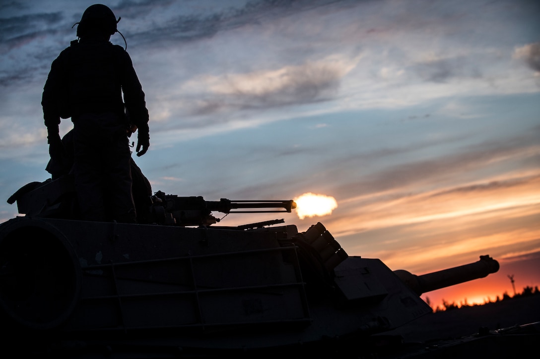 Marines with Bravo Company, 4th Tanks Battalion, prepare to fire a 50 cal. machine gun mounted on a M1A1 Abrams tank during Exercise Arrow 18 in Pohjankangas Training Area near Kankaanpaa, Finland, May 17, 2018. Exercise Arrow is an annual Finnish multi-national exercise with the purpose of training with mechanized infantry, artillery, and mortar field training skills in a live-fire exercise. This is the first year the Marine Corps is participating in this exercise and the first time the M1A1 Abrams tanks have been in Finland. (U.S. Marine Corps photo by Staff Sgt. Marcin Platek/Released)