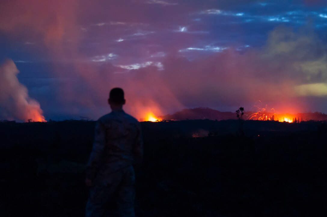 A member of the Hawaii Air National Guard observes three lava fissures at the Leilani Estates and Lanipuna Gardens subdivisions in Pahoa, Hawaii.