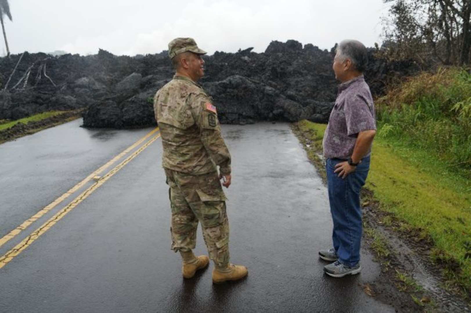 Brig. Gen. Kenneth Hara, Joint Task Force 5-0 commander, and Hawaii Gov. David Ige examine an area in Leilani Estates where lava over ran the road, May 08, 2018, Pahoa Hawaii.