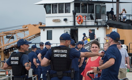 U.S. Coast Guard members interact with attendees during an open house at Coast Guard Sector Charleston, S.C., May 19, 2018.