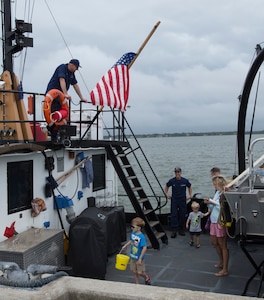 Attendees tour a U.S. Coast Guard boat during an open house at Coast Guard Sector Charleston, S.C., May 19, 2018.