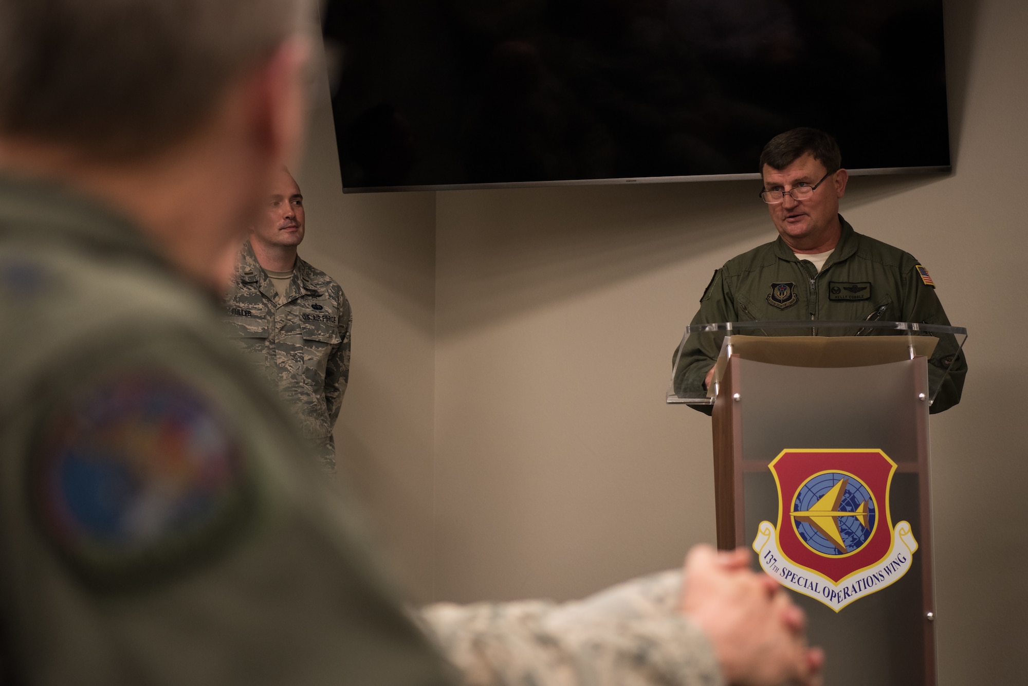 Col. Kelly W. Cobble, exiting commander of the 137th Special Operations Group, speaks to attendees of the Group’s change of command ceremony at Will Rogers Air National Guard Base in Oklahoma City, May 17, 2018. Col. Daniel R. “Pinto” Fowler, formerly the Air National Guard's Advisor to U.S. Air Force Special Operations Command, Hurlbert Field, Fla., assumed command with more than 20 years of military experience, including three years as a Joint Terminal Attack Control qualified Air Liaison Officer and 12 years of flying. (U.S. Air National Guard photo by Staff Sgt. Kasey Phipps)