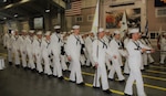 IMAGE: GREAT LAKES, Ill. (May 18, 2018) - Recruit Division 213 marches with the Naval Surface Warfare Center Dahlgren Division Dam Neck Activity flag (blue, at right) at their graduation ceremony. NSWCDD Dam Neck Activity Commanding Officer Cmdr. Andrew J. Hoffman led a contingent at graduation after another contingent participated in the division's Battle Stations 21 drills and Capping Ceremony earlier in the week.