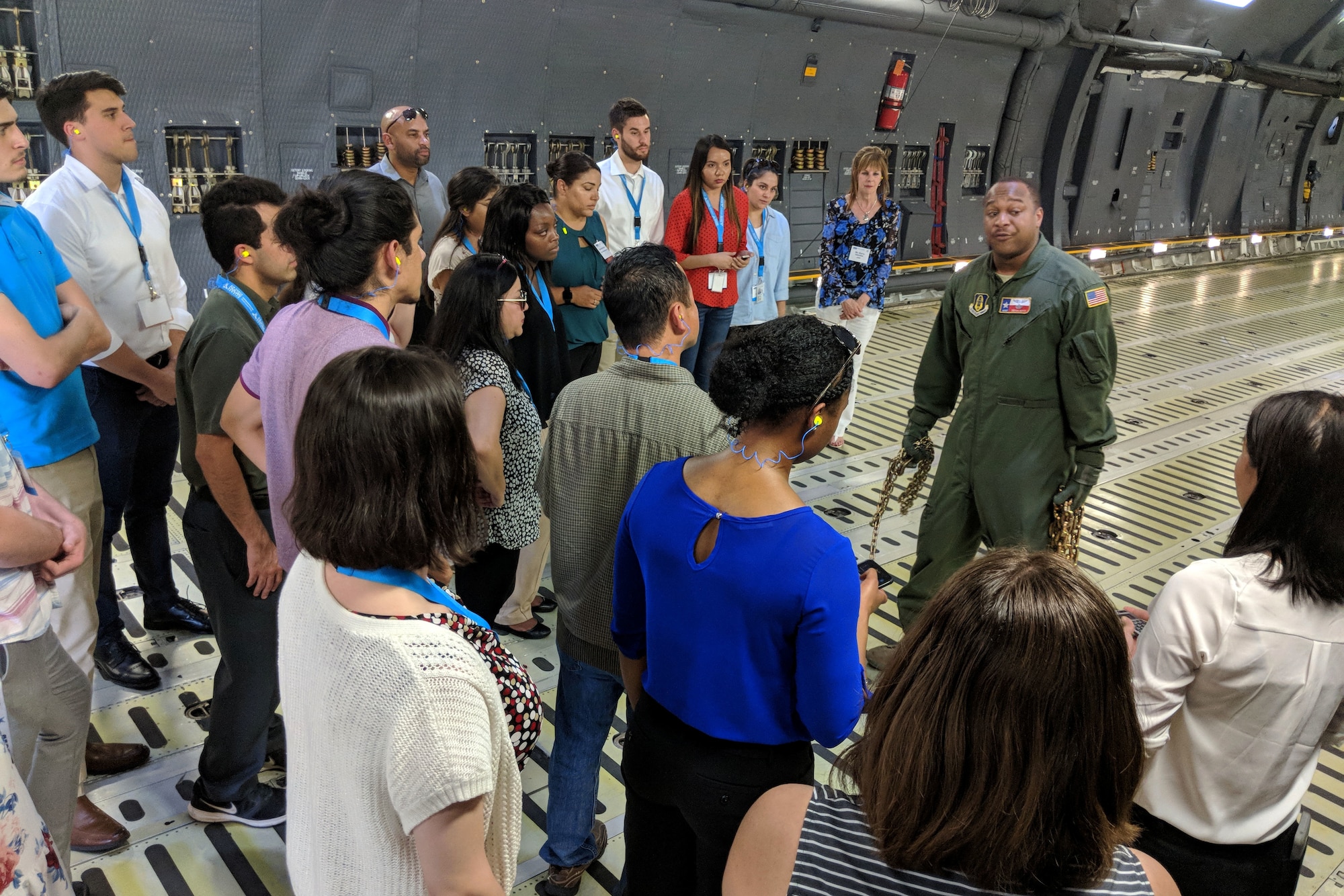 U.S. Air Force Master Sgt. Bryan Boyd, 356th Airlift Squadron loadmaster, gives a brief lesson to college students in what it takes to load a C-5M Super Galaxy during an Air Force Personnel Center Premier College Intern Program symposium tour to the 433rd Airlift Wing May 16, 2018, at Joint Base San Antonio-Lackland, Texas. Tour members were able to handle chains and calculate requirements during the tour. (U.S. Air Force photo by Staff Sgt. Lauren M. Snyder)