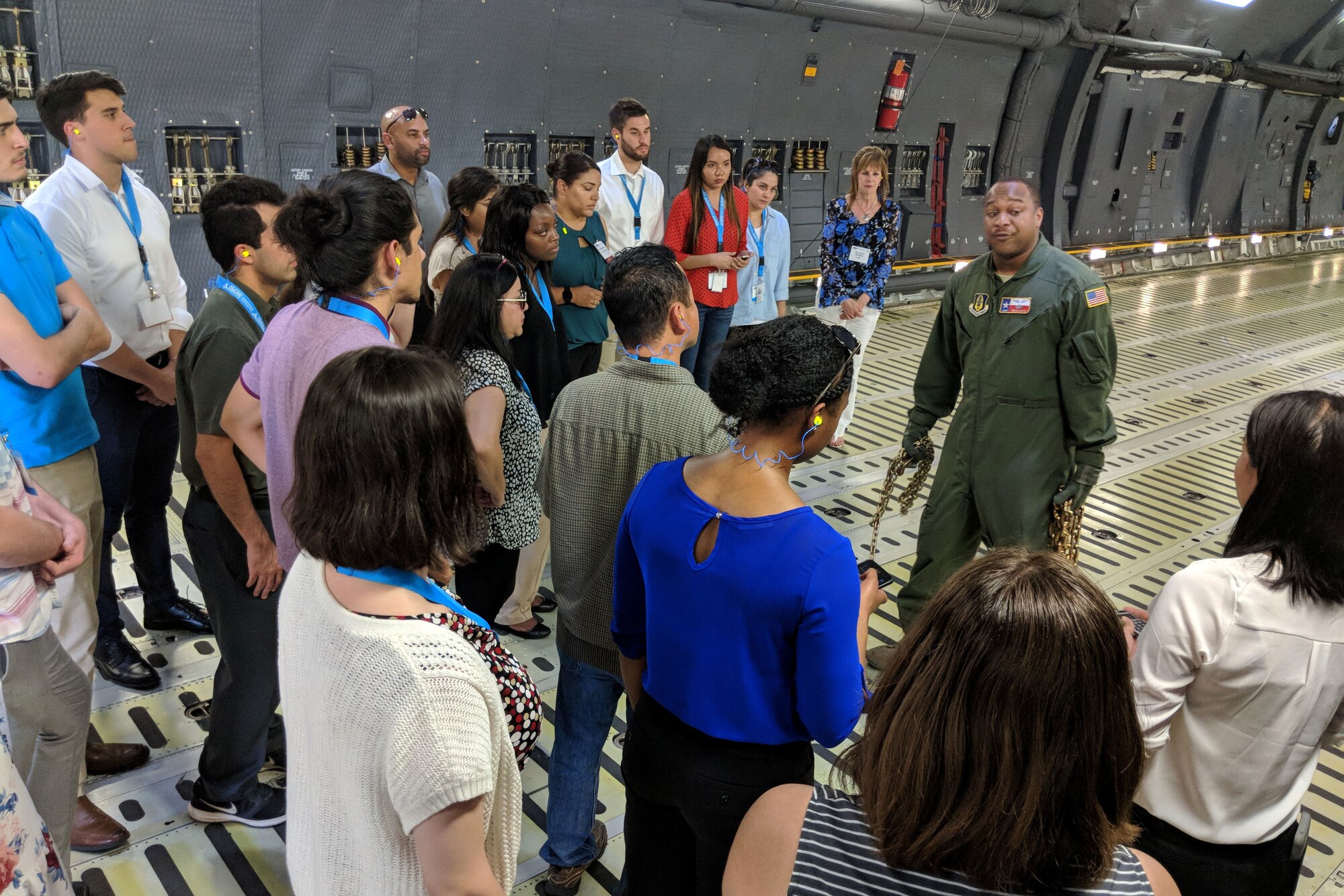 U.S. Air Force Master Sgt. Bryan Boyd, 356th Airlift Squadron loadmaster, gives a brief lesson to college students in what it takes to load a C-5M Super Galaxy during an Air Force Personnel Center Premier College Intern Program symposium tour to the 433rd Airlift Wing May 16, 2018, at Joint Base San Antonio-Lackland, Texas. Tour members were able to handle chains and calculate requirements during the tour. (U.S. Air Force photo by Staff Sgt. Lauren M. Snyder)