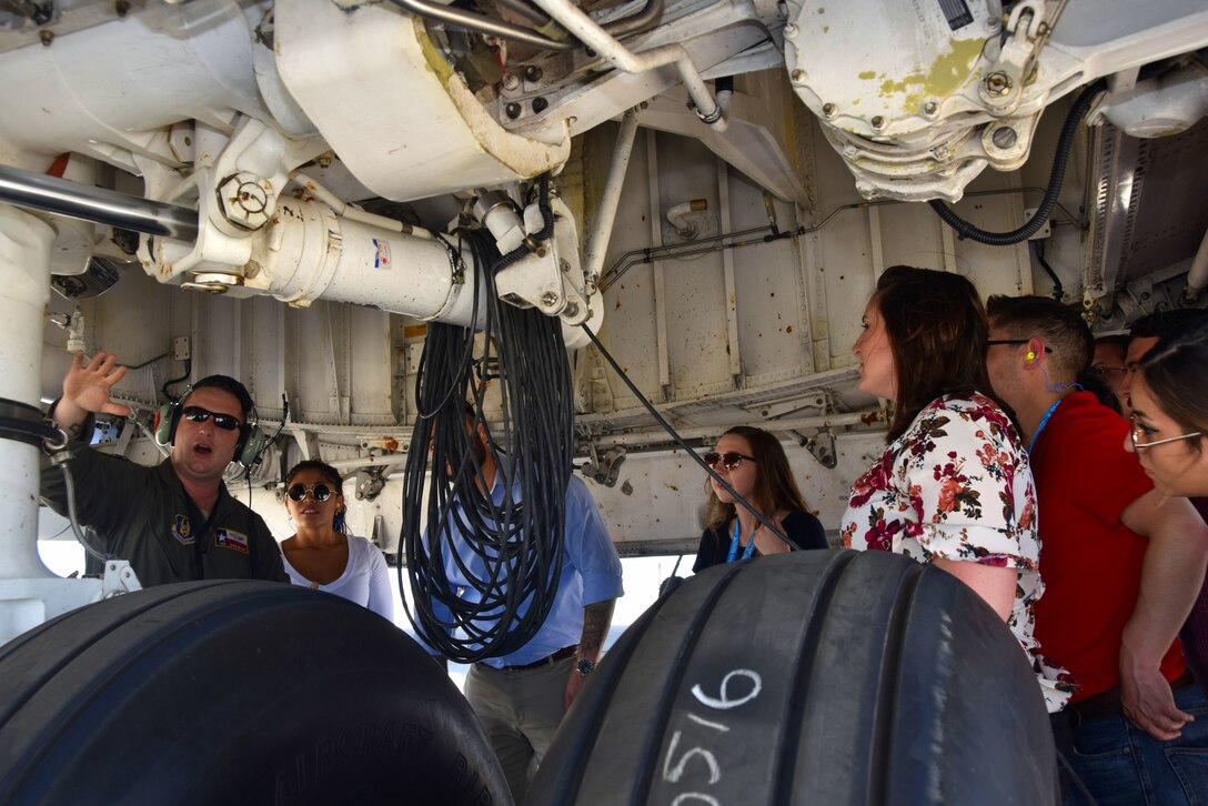 - U.S. Air Force Tech. Sgt. Duane Bryant, 356th Airlift Squadron loadmaster, discusses the landing gear of a C-5M Super Galaxy to an Air Force Personnel Center Premier College Intern Program interns during a tour to the 433rd Airlift Wing May 16, 2018, at Joint Base San Antonio-Lackland, Texas. The interns will start a 12-week paid internship while serving throughout JBSA. (U.S. Air Force photo by Tech. Sgt. Iram Carmona)