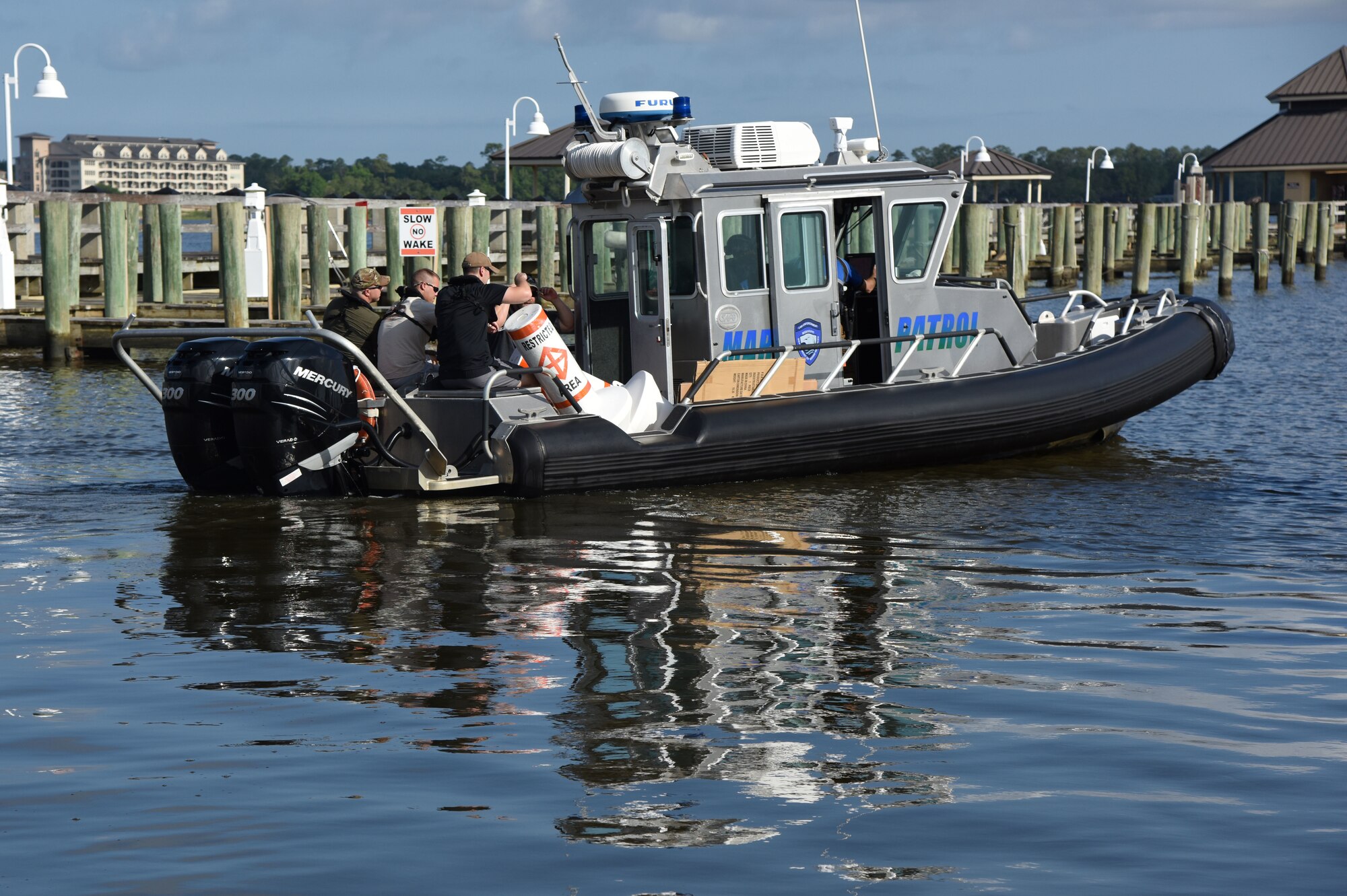 Members of the 81st Security Forces Squadron and the Department of Marine Resources head toward the Biloxi Back Bay inside The Marina at Keesler Air Force Base, Mississippi, May 23, 2018. Keesler and the Department of Marine Resources partnered to install 15 buoys in the Biloxi Back Bay 150 feet from the Keesler shore line as an added base security measure. (U.S. Air Force photo by Kemberly Groue)