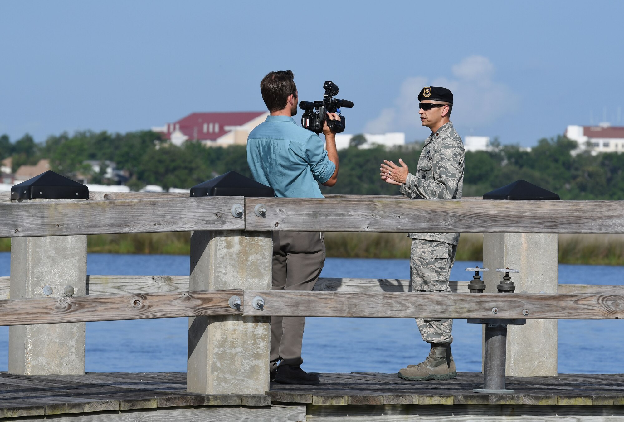 Jonathan Brannan, WLOX News reporter, interviews U.S Air Force Maj. Jonathon Murray, 81st Security Forces Squadron commander, at The Marina at Keesler Air Force Base, Mississippi, May 23, 2018. Keesler and the Department of Marine Resources partnered to install 15 restricted area buoys in the Biloxi Back Bay 150 feet from the Keesler shore line as an added base security measure. (U.S. Air Force photo by Kemberly Groue)