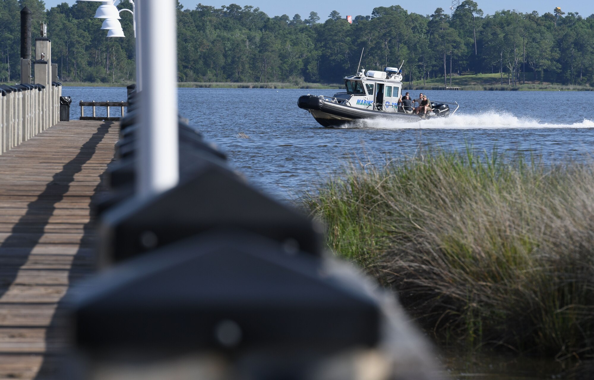 Members of the 81st Security Forces Squadron and the Department of Marine Resources drive through the Biloxi Back Bay to install 15 buoys 150 feet from the Keesler shore line as an added base security measure near Keesler Air Force Base, Mississippi, May 23, 2018. This project took almost two years of research and coordination with the 81st SFS Anti-terrorism Office, 81st Training Wing Legal Office, the state of Mississippi as well as the Army Corps of Engineers in Washington, D.C. (U.S. Air Force photo by Kemberly Groue)