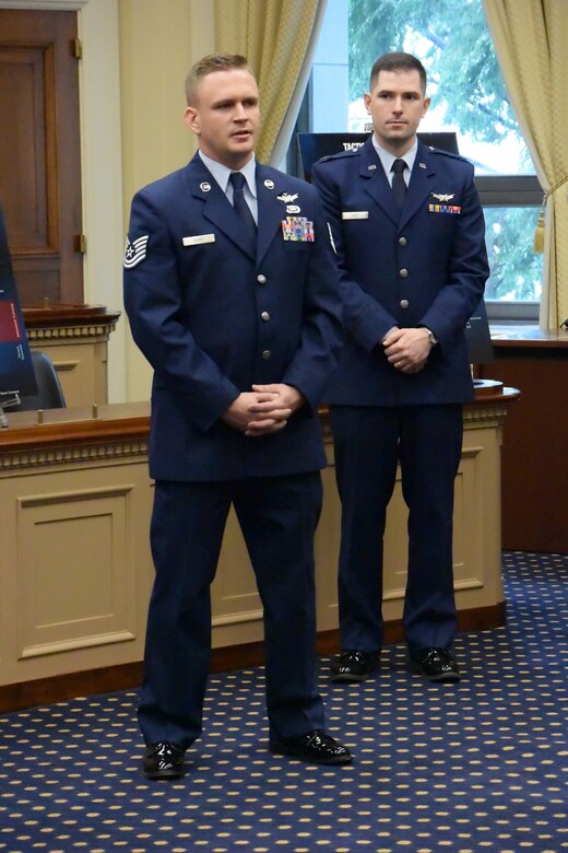 Tech. Sgt. Jon Hart, space operator with the 1st Space Operations Squadron, and Capt. Nate Lee, space officer with the 527th Space Aggressor Squadron,  explain how realistic training events develop warfighter expertise during the Space Power Social in the House Science, Space and Technology Committee Hearing Room, Washington, May 17, 2018.  The pair were among several space experts on hand to personify the Air Force’s efforts to ensure our continued space superiority.  (U.S. Air Force photo by Jennifer Thibault)