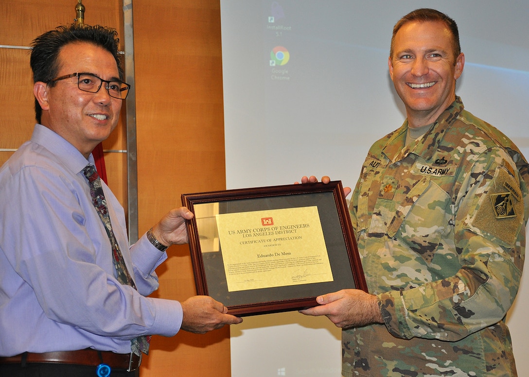Maj. Scotty Autin, deputy commander for the U.S. Army Corps of Engineers Los Angeles District, right, presents Ed De Mesa, chief of the Planning Division for the LA District, left, with a certificate thanking him for being the speaker at the District’s Asian American/Pacific Islander Heritage Month Observance May 22 at the District headquarters in downtown LA.