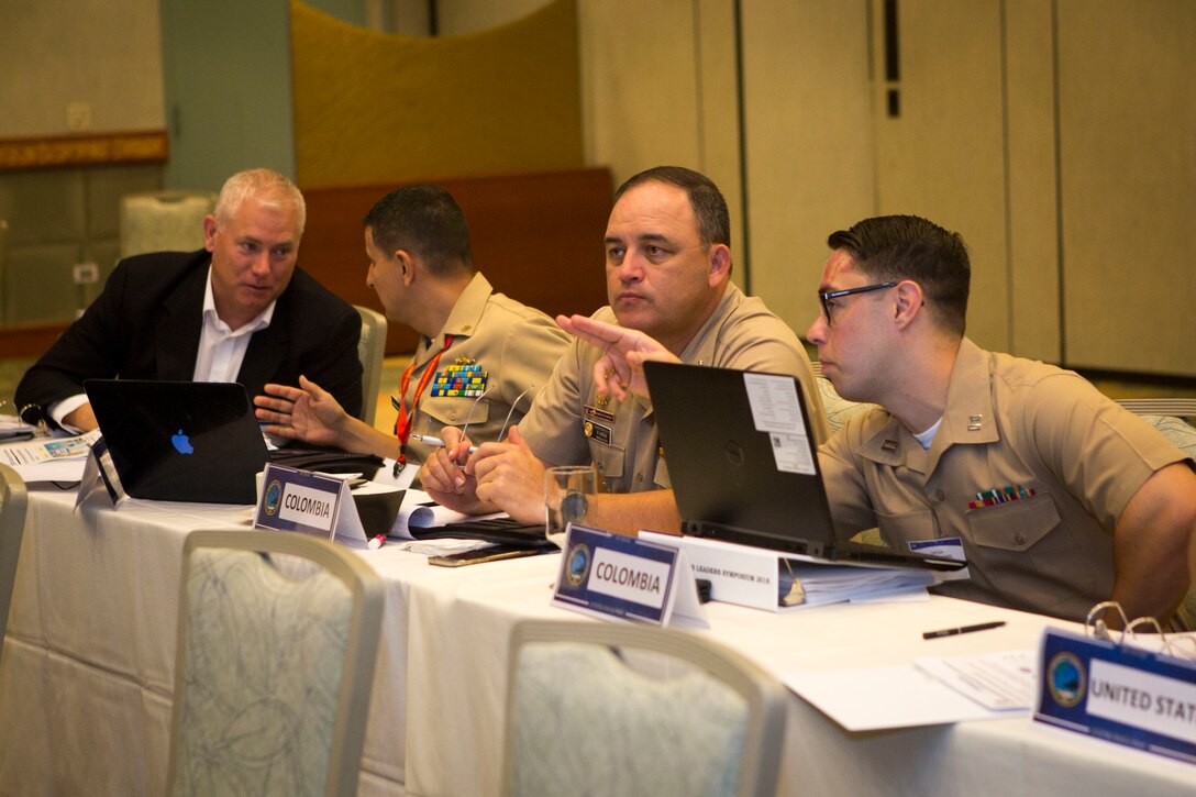 Colombian and U.S. military personnel share information during the Pacific Amphibious Leaders Symposium 2018 in Honolulu, Hawaii, May 23, 2018. During the symposium, military services from around the world build a closer military-to-military bond with one another. Closer bonds between other militaries facilitate clear lines of communication and foster a spirit of cooperation to meet potential global challenges. (U.S. Marine Corps photo by Sgt. Jonathan E. Lopez Cruet)