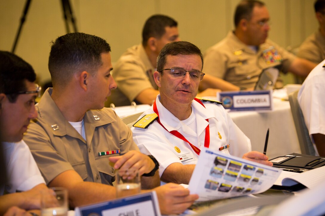 U.S. Marine Corps Capt. Andres Vasquez, left, deputy staff judge advocate, U.S. Marine Corps Forces, South, translates for Chilean Marine Corps Rear Adm. Pedro Ábrego Martínez, commanding general, Chilean Marine Corps, during the Pacific Amphibious Leaders Symposium (PALS) 2018 in Honolulu, Hawaii, May 23, 2018. During the symposium, military services from around the world build a closer military-to-military bond with one another. Closer bonds between other militaries facilitate clear lines of communication and foster a spirit of cooperation to meet potential global challenges. (U.S. Marine Corps photo by Sgt. Jonathan E. Lopez Cruet)