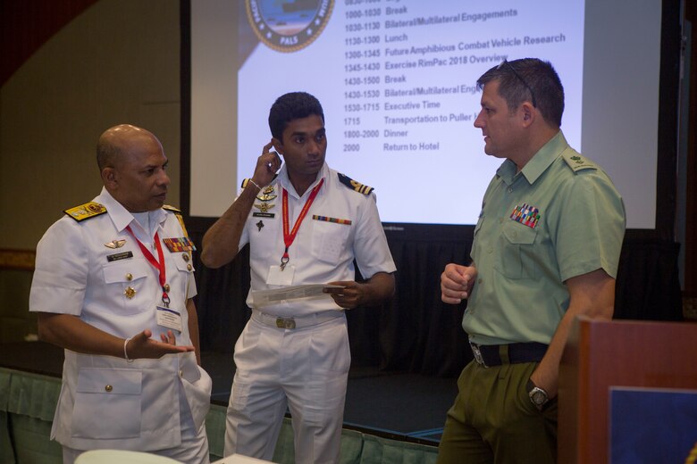 Sri Lanka Navy Rear Adm. Udeni Indranatha Serasinghe, left, director, Naval Land Operations and director Marine at Naval Headquarters, left, speaks to New Zealand Lt. Col. Marcus Linehan, right, Headquarters Joint Force New Zealand, New Zealand Defence Force, during the Pacific Amphibious Leaders Symposium 2018 in Honolulu, Hawaii, May 23, 2018.