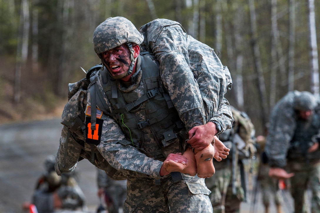 A soldier evacuates a simulated casualty.