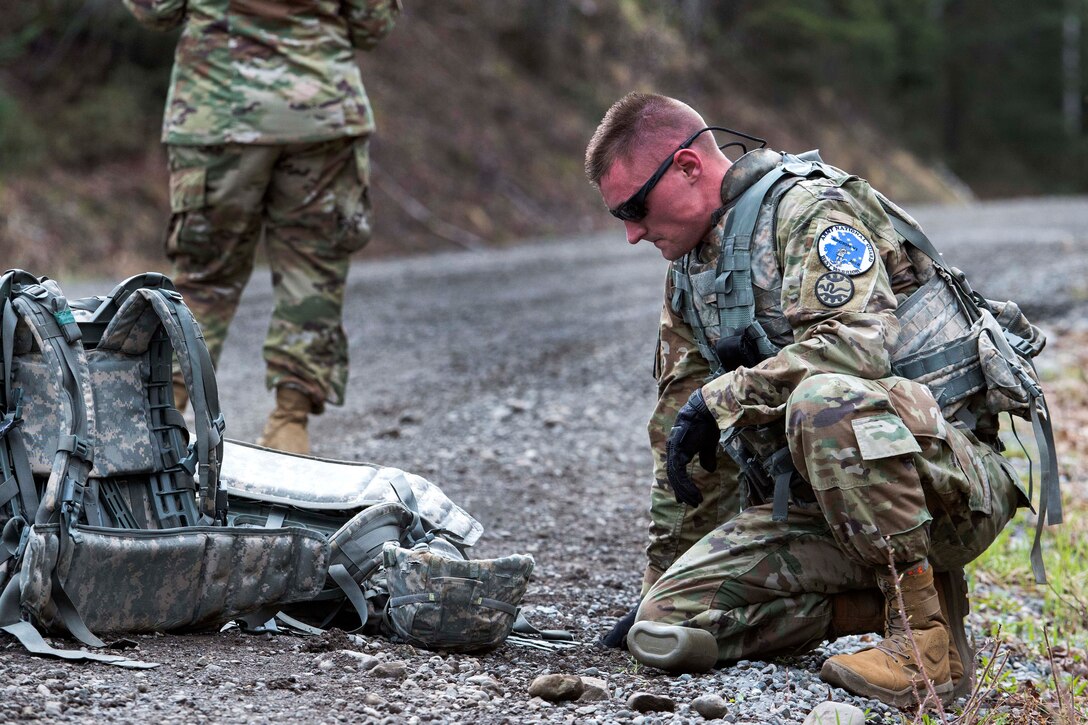 A soldier takes a break after completing the equipment run.