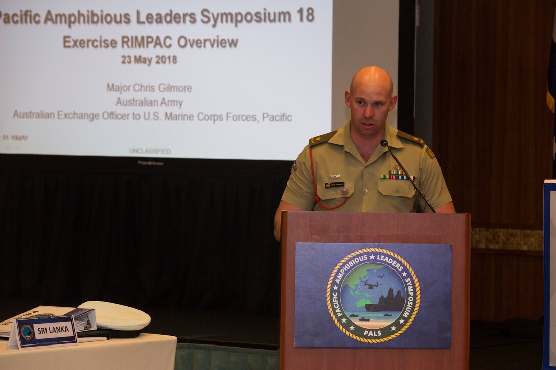 Australian Army Maj. Chris Gilmore, Australian Exchange Officer to U.S. Marine Corps Forces, Pacific, gives a brief on RIMPAC during the Pacific Amphibious Leaders Symposium 2018 in Honolulu, Hawaii, May 23, 2018. During the symposium, military services from around the world build a closer military-to-military bond with one another. Closer bonds between militaries facilitate clear lines of communication and foster a spirit of cooperation to meet potential global challenges. (U.S. Marine Corps photo by Cpl. Patrick Mahoney)