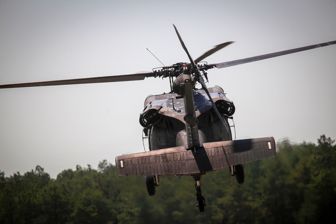 An Army UH-60L Black Hawk helicopter takes off.