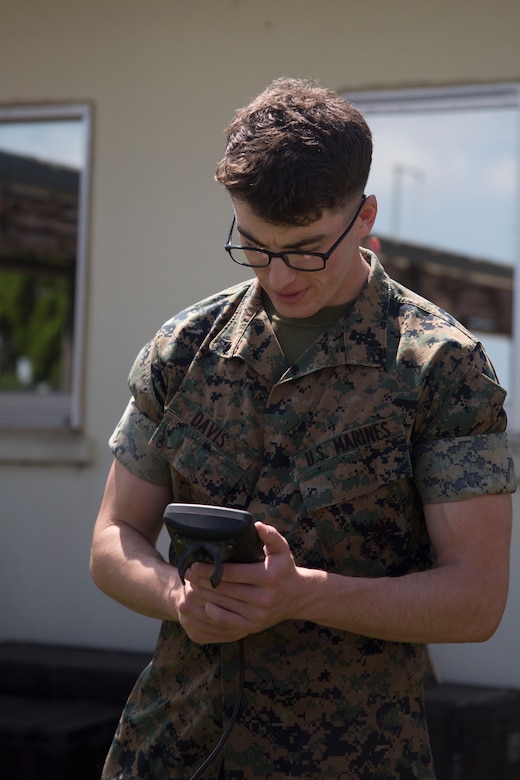 MCAS FUTENMA, OKINAWA, Japan – Lance Cpl. Elijah Davis looks at one of the monitors of a weather local substation May 15 aboard Marine Corps Air Station Futenma, Okinawa, Japan.