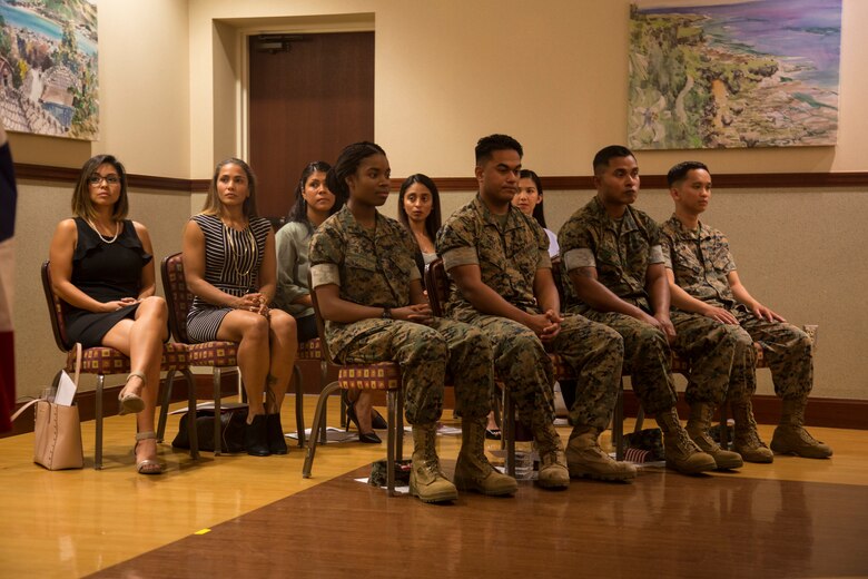 CAMP FOSTER, OKINAWA, Japan – New U.S. citizens sit during a naturalizing ceremony May 17 hosted at the Ocean Breeze aboard Camp Foster, Okinawa, Japan.
