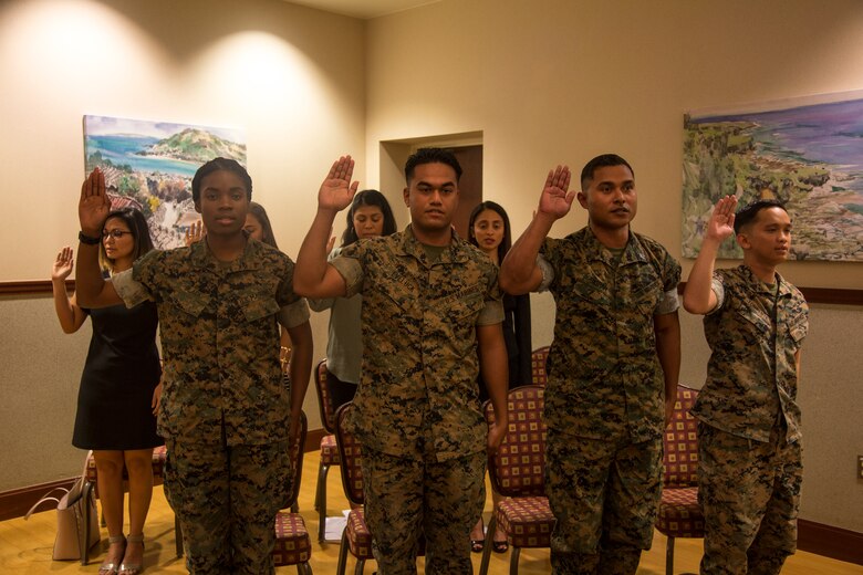 CAMP FOSTER, OKINAWA, Japan –New U.S. citizens recite the Oath of Allegiance during a nationalization ceremony May 17 hosted at the Ocean Breeze aboard Camp Foster, Okinawa, Japan.