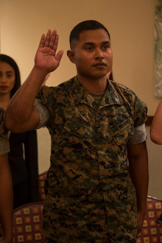 CAMP FOSTER, OKINAWA, Japan – Sgt. Nelson Sigrah recites the Oath of Allegiance during the naturalization ceremony May 17 hosted at the Ocean Breeze aboard Camp Foster, Okinawa, Japan.