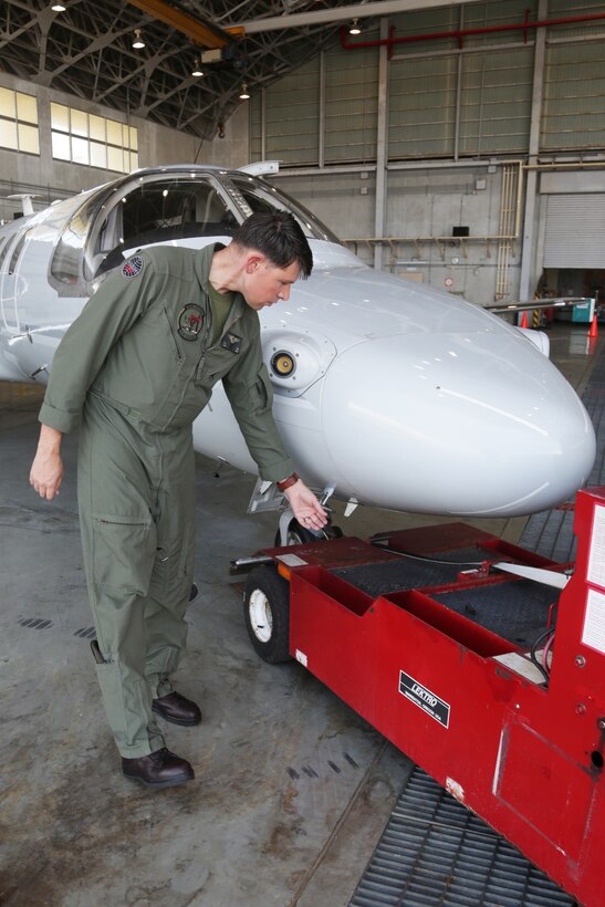 MCAS FUTENMA, OKINAWA, Japan – Capt. Benjamin Vigil preforms a preflight check of an aircraft May 22 on Marine Corps Air Station Futenma, Okinawa, Japan.
