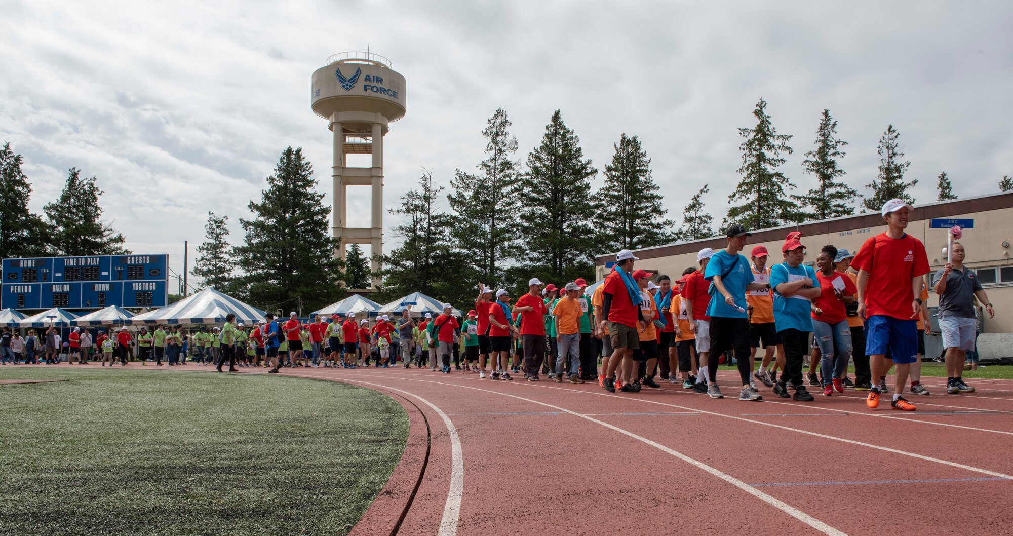 Athletes and volunteers march in the opening parade of the Kanto Plains Special Olympics at Yokota Air Base, Japan, May 19, 2018.
