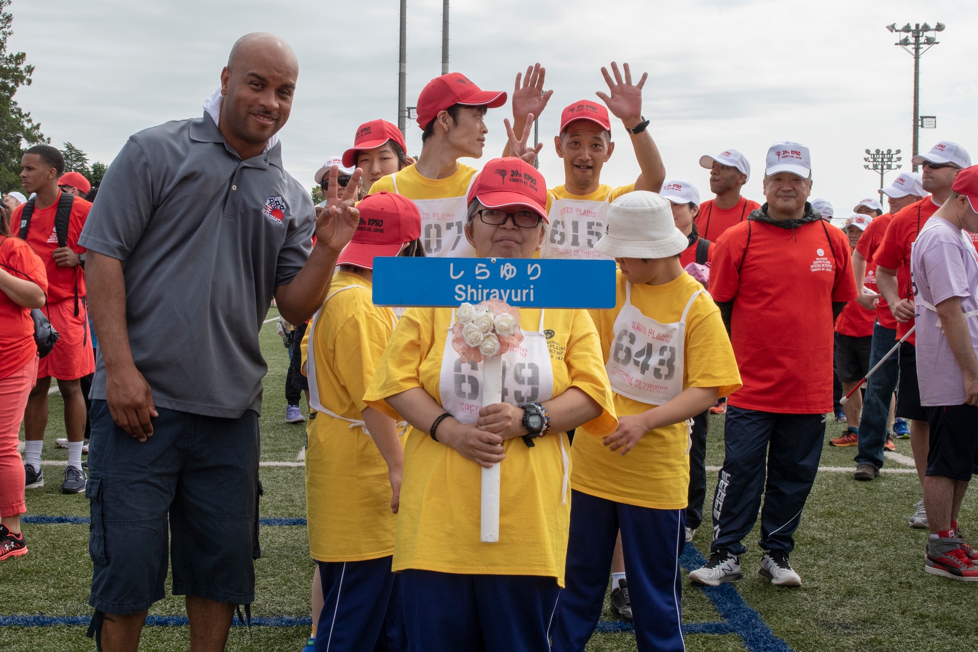 The athletes and coaches from Shirayuri pose for a photo immediately following the parade portion of the Kanto Plains Special Olympics at Yokota Air Base, Japan, May 19, 2018.