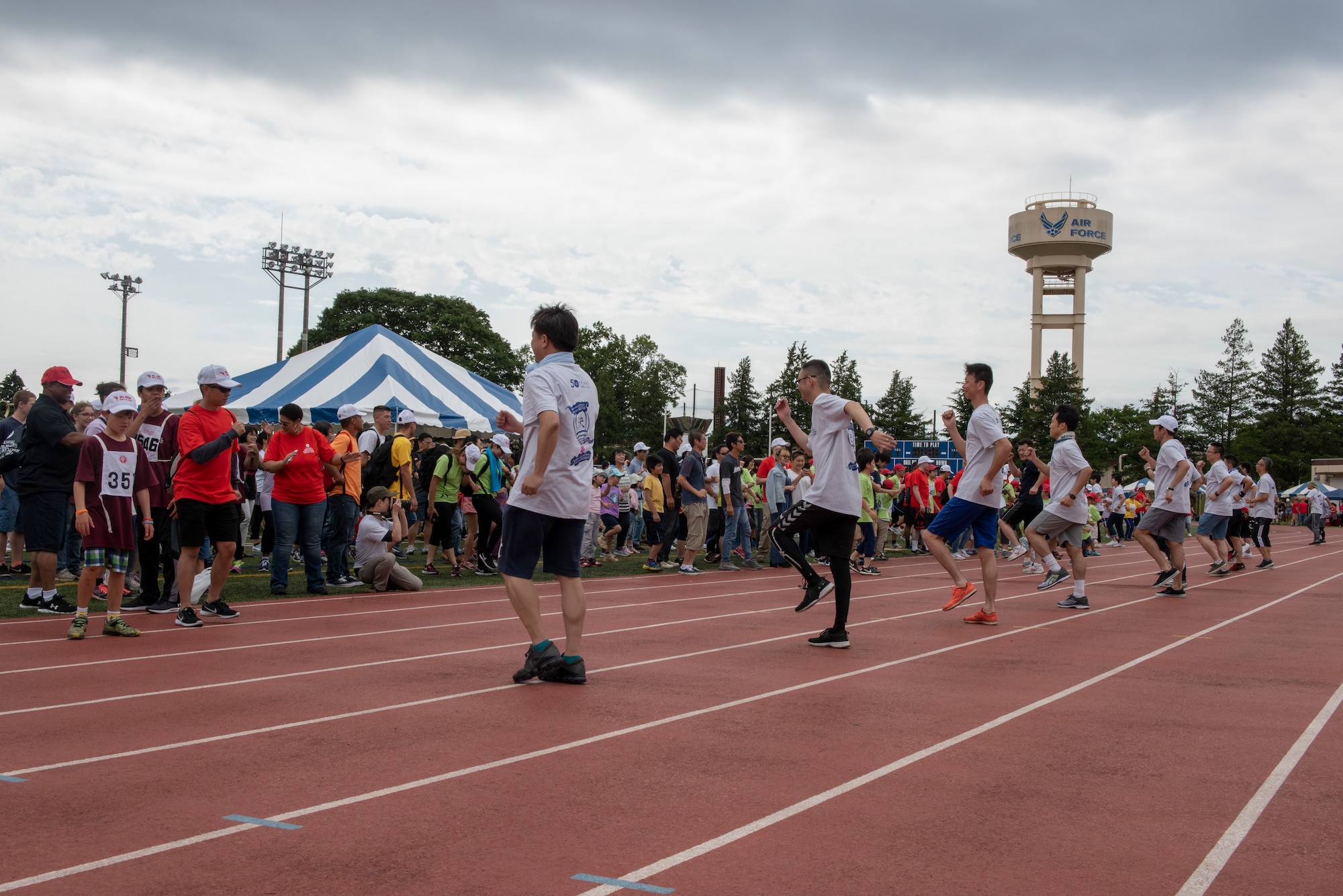 A set of volunteers leads warm-up exercises at the Kanto Plains Special Olympics at Yokota Air Base, Japan, May 19, 2018.