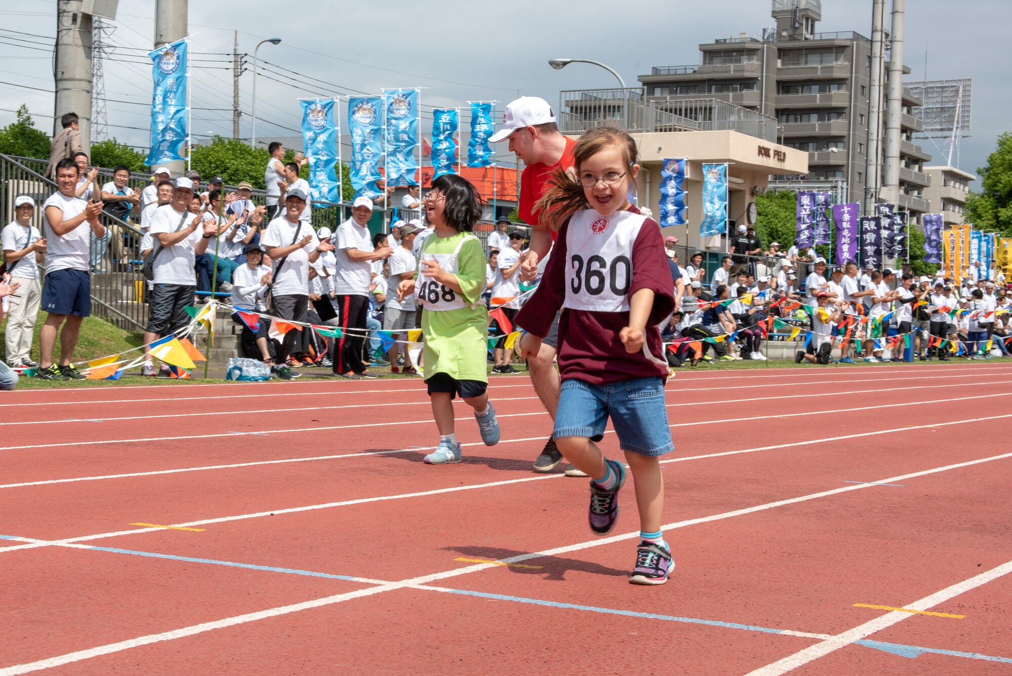 An athlete sprints to the finish line in the 50 meter race during the Kanto Plains Special Olympics at Yokota Air Base, Japan, May 19, 2018.