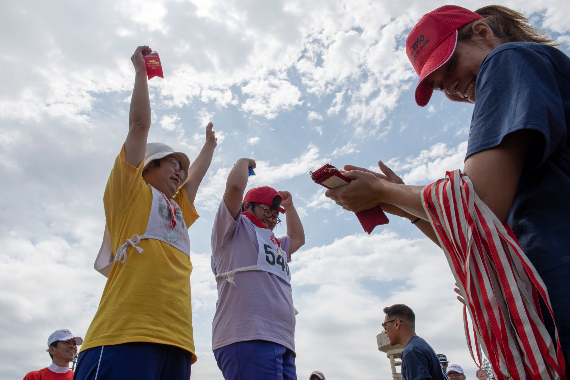 Athletes celebrate receiving their medals during the medal ceremony of the 50 meter sprint during the Kanto Plains Special Olympics at Yokota Air Base, Japan, May 19, 2018.