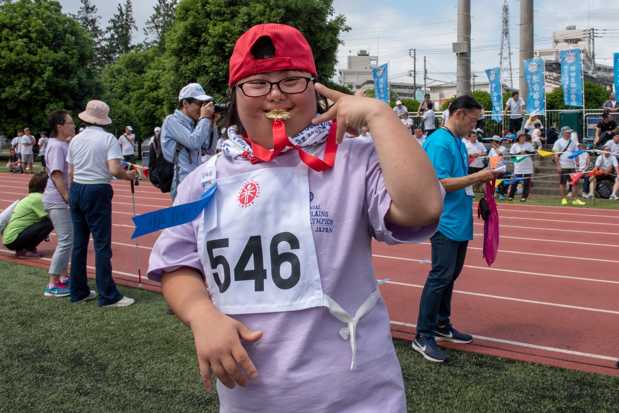 An athlete poses for a photo after winning gold in the 50 meter sprint during the Kanto Plains Special Olympics at Yokota Air Base, Japan, May 19, 2018.