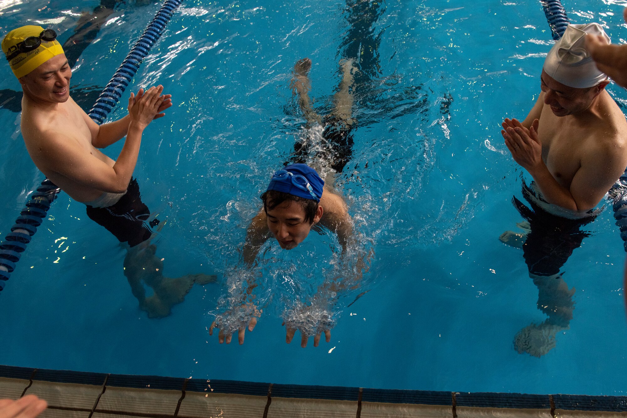 An athlete lunges for the wall during the 15 meter water walking competition during the Kanto Plains Special Olympics at Yokota Air Base, Japan, May 19, 2018.