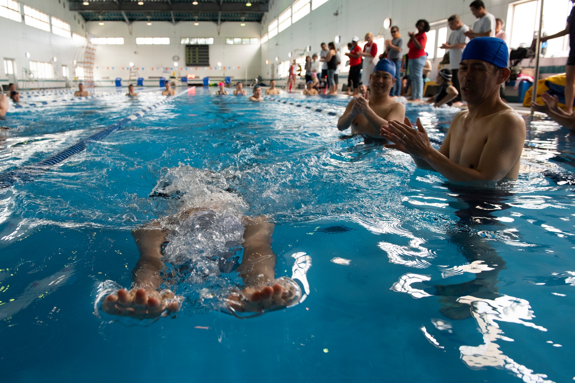 An athlete stretches out to grab the wall while competing in the 15 meter breaststroke race during the Kanto Plains Special Olympics at Yokota Air Base, Japan, May 19, 2018.
