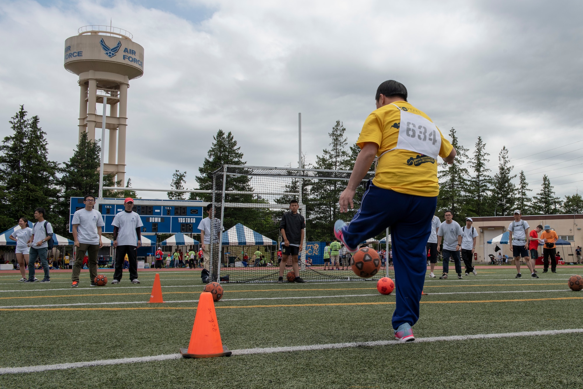 An athlete strikes the ball towards goal during the soccer shoot competition of the Kanto Plains Special Olympics at Yokota Air Base, Japan, May 19, 2018.