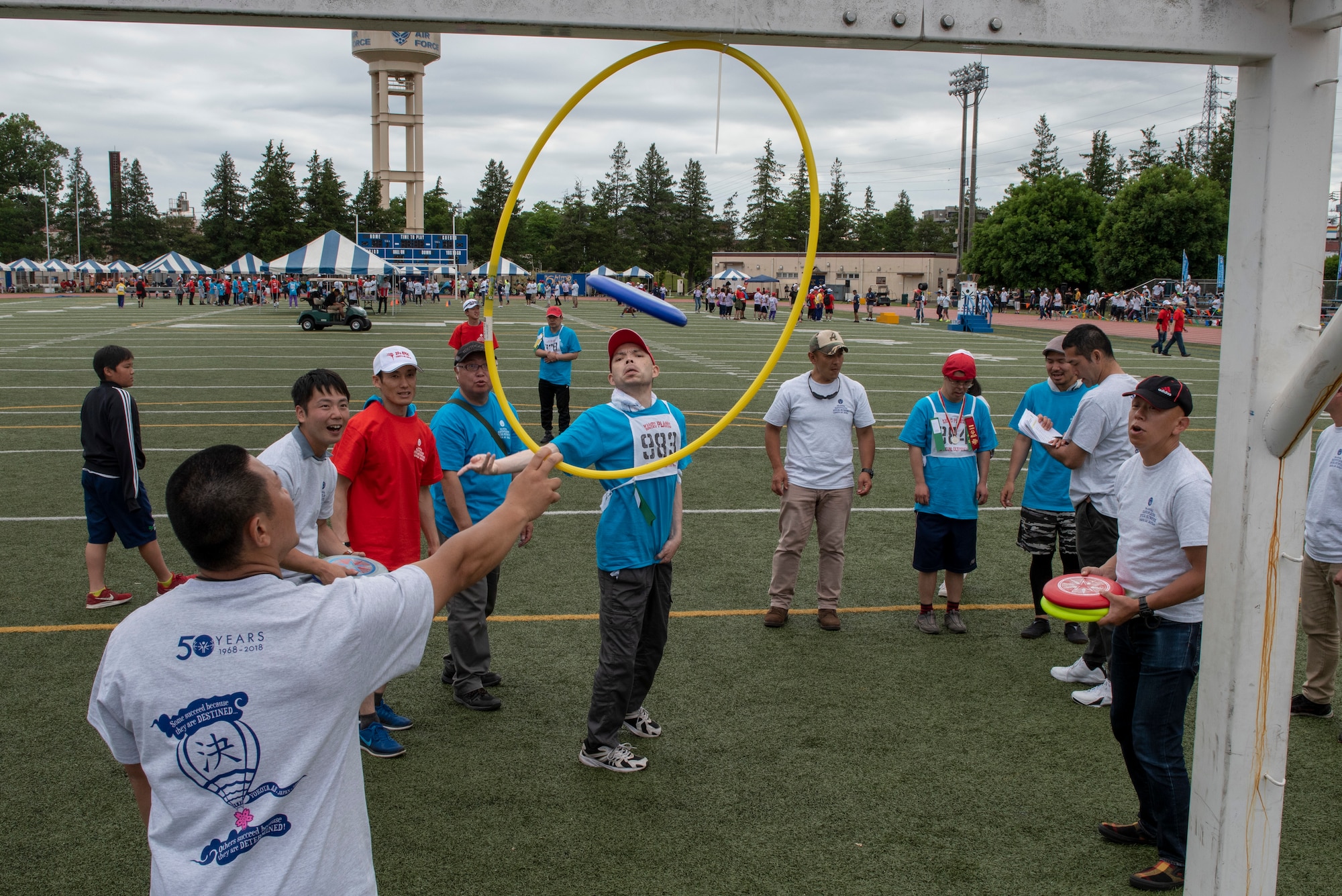 An athlete tosses a Frisbee through a hoop of the flying disc competition during the Kanto Plains Special Olympics at Yokota Air Base, Japan, May 19, 2018.