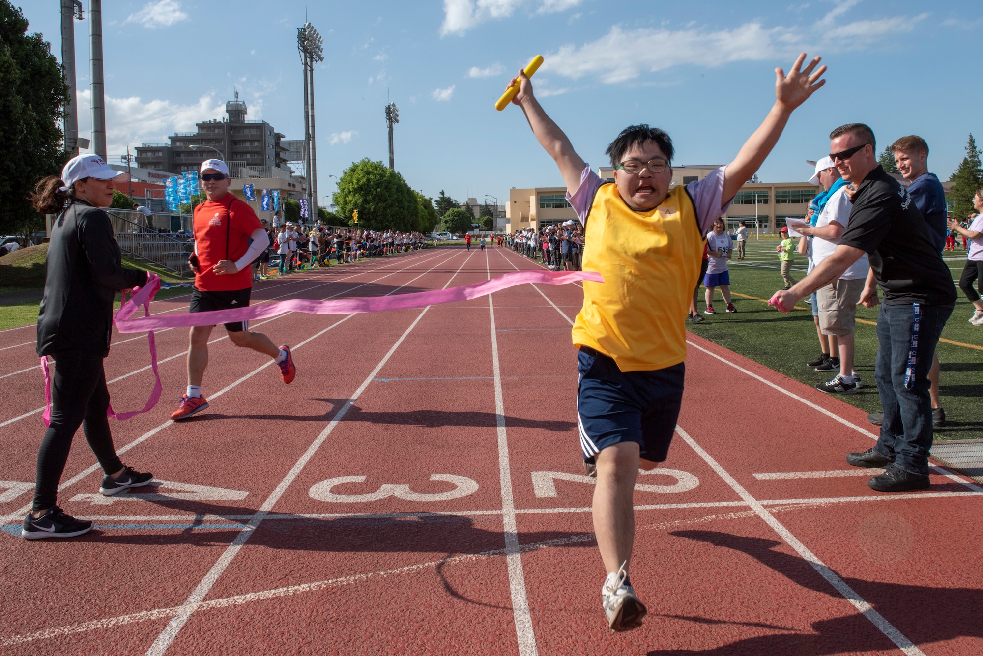 An athlete sprints through the finish line of the 4x100 meter relay race during the Kanto Plains Special Olympics at Yokota Air Base, Japan, May 19, 2018.