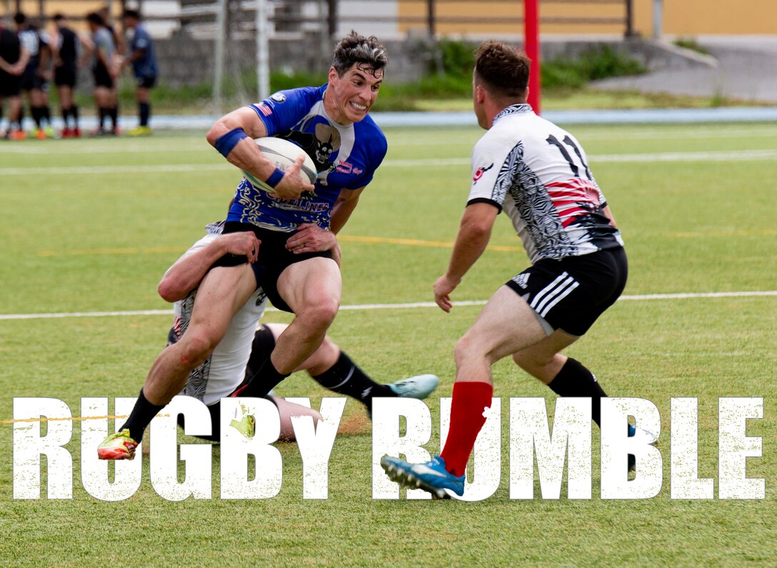 U.S. Air Force 1st Lt. Lee Kozokas, left, an airborne intelligence officer with the 390th Intelligence Squadron, attempts to shake off his opponent during a rugby tournament game May 20, 2018, at Okinawa International University Ginowan, Okinawa, Japan. (U.S. Marine Corps photo by Pfc. Terry Wong)