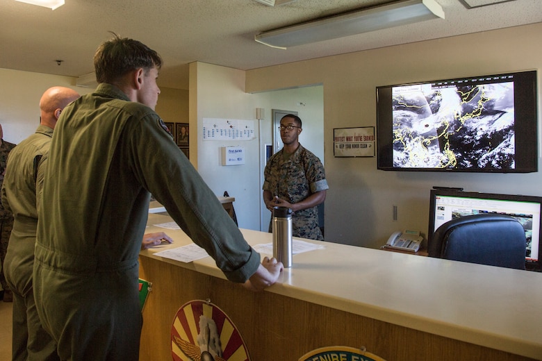 Cpl. Darien Huggins brief pilots on the weather patterns and wind conditions before a training flight May 22 at Marine Corps Air Station Futenma, Okinawa, Japan. Pilots receive a preflight brief that consists of weather and wind patterns for the next 24 hours to help them build a picture of any challenges they may face in the air.  Huggins is a meteorology and oceanology analyst forecaster with Headquarter and Headquarter Support, MCAS Futenma.