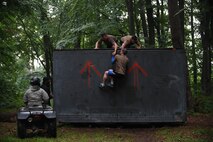 Kaiserslautern Military Community service members work together to climb over a wall during the 2018 Ramstein Mudder, May 24 at Ramstein Air Base, Germany. More than 200 Kaiserslautern Military Community Members ran the 2.5 mile obstacle course for the 86th Airlift Wing’s resilience day. (U.S. Air Force photo by Staff Sgt. Nesha Humes Stanton)