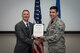 Staff Sgt. Joshua Bevins stands with Dr. Kevin Geiss, Airman Systems Directorate director, after being awarded with the Air Force Achievement Medal. Bevins and another Airman worked as a team to help a choking coworker. (U.S. Air Force photo/Richard Eldridge)