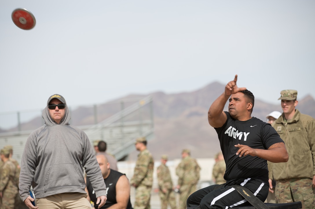 Soldier in civilian clothes competes in field event.